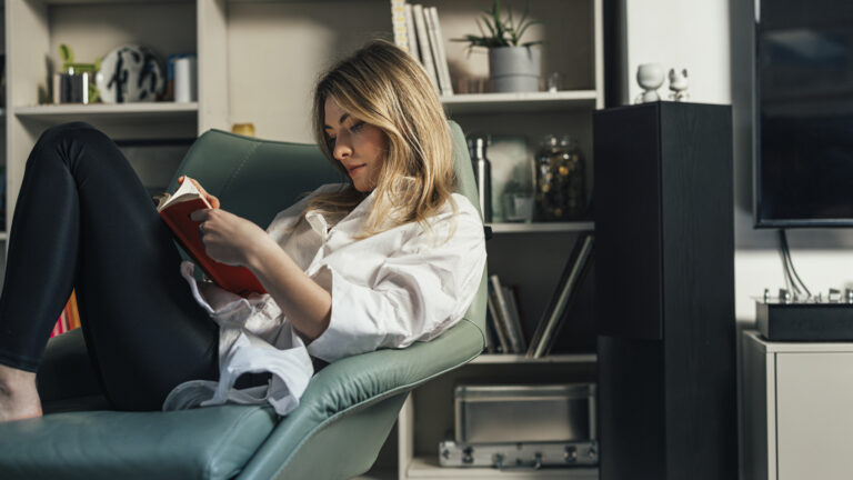 Woman in a chair does her reading habit