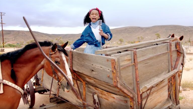 A young  girl singing 'Old Town Road' by Lil Nas X.