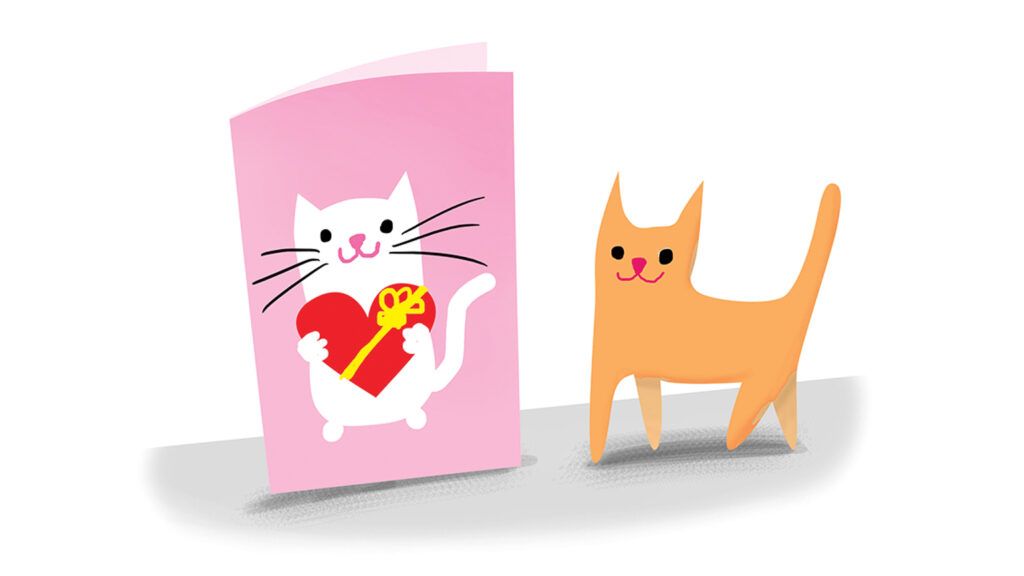 A Valentine's Day card with a cat on it next to an actual feline.