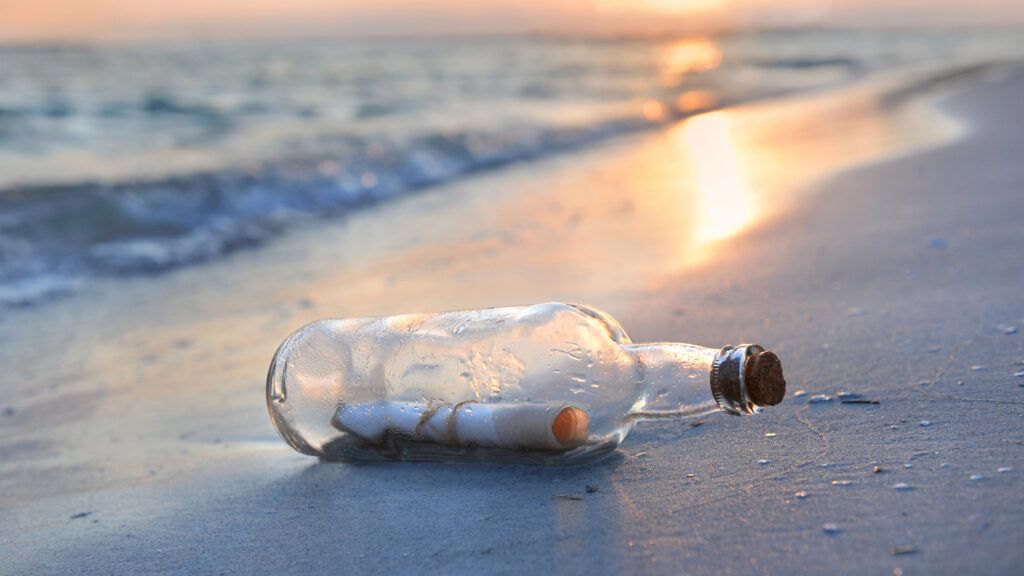 A message in a bottle on the beach.