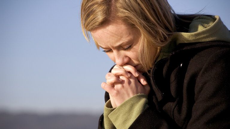 A woman prays for forgiveness
