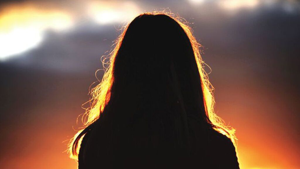 A silouette of the back of a woman's head in mystical light.