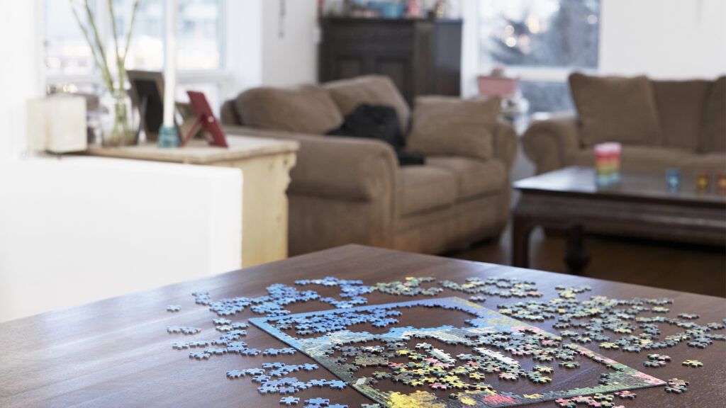 A teenager doing a jigsaw puzzle.