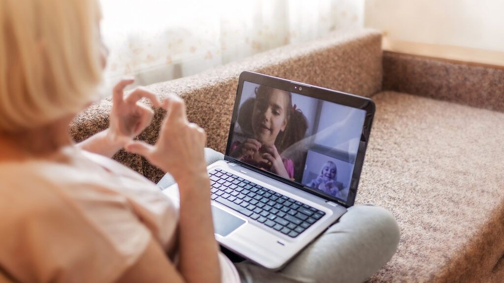 A woman video chatting with her granddaughter.