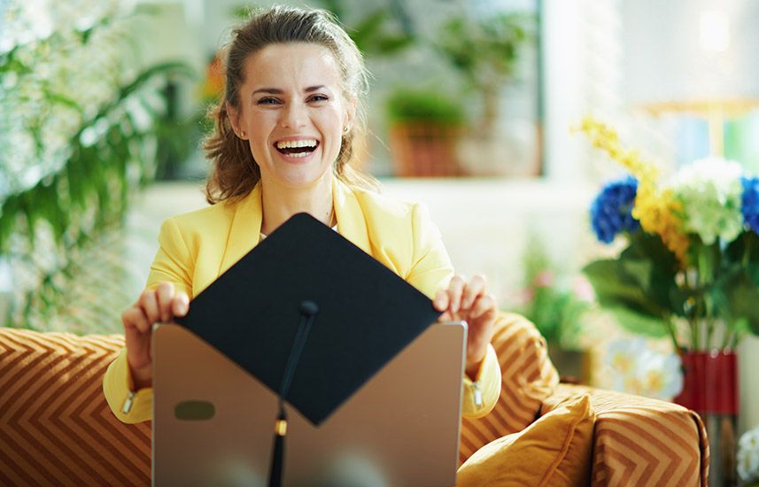 Young woman having a virtual graduation celebration