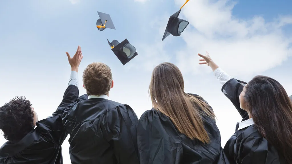 Graduates throw their caps in the air