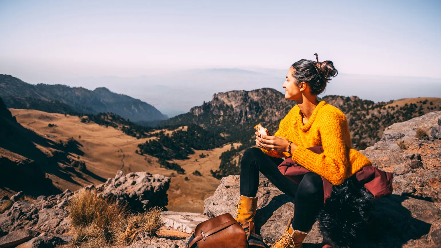 A woman eating lunch in the great outdoors.