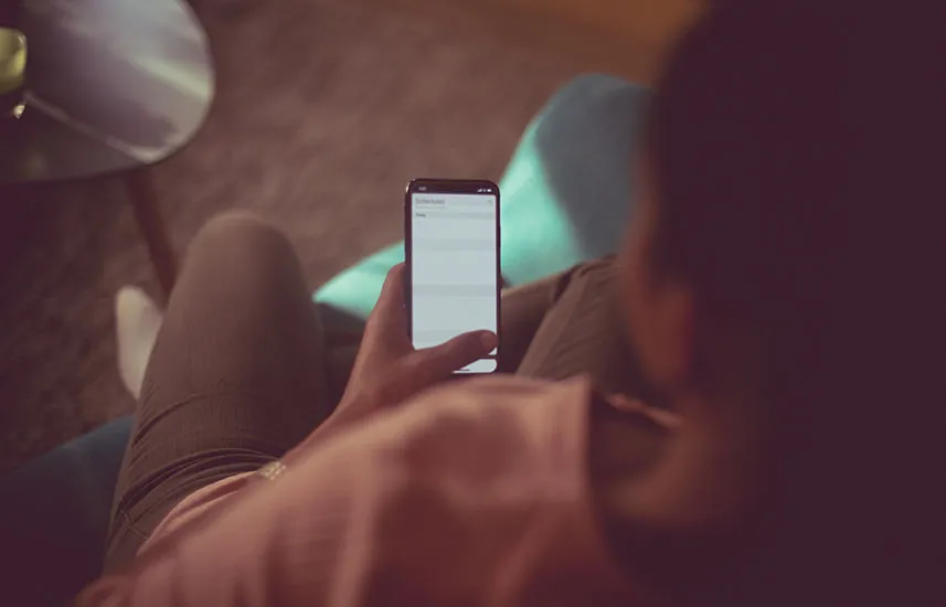 Woman at home looking at her phone