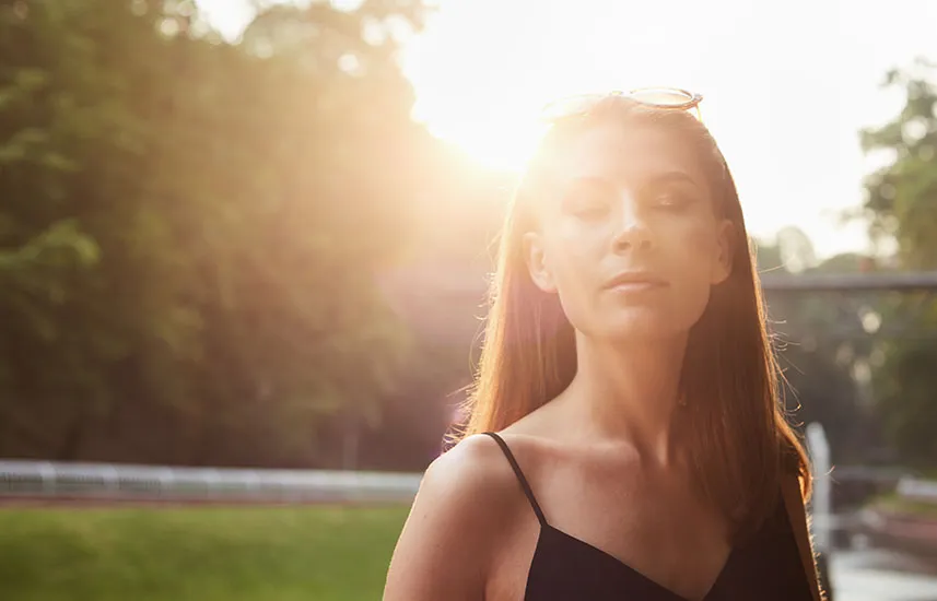 Woman outdoors with her eyes closed