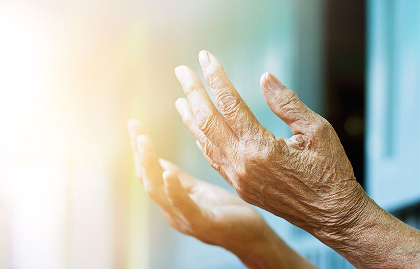 Elderly woman holding her hands out