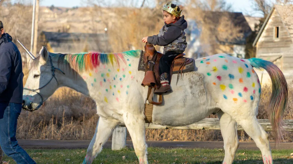 Wyatt Haas riding a unicorn at his surprise party