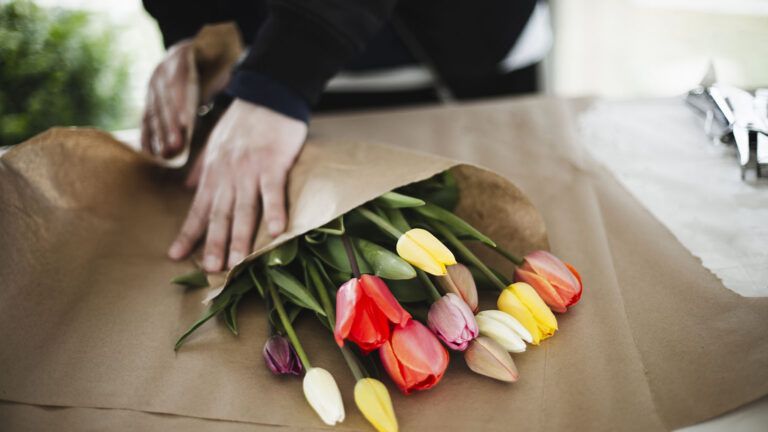 Man wrapping tulips