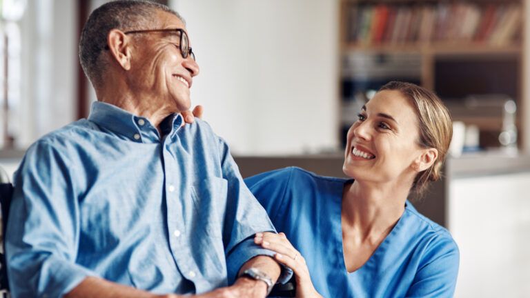 An in-home caregiver smiling at her client.