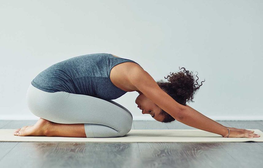 Woman stretching on a yoga mat