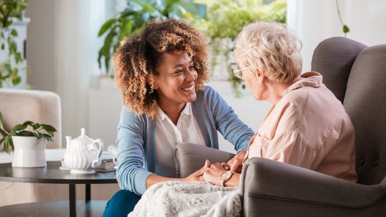Caregiver talking to senior woman