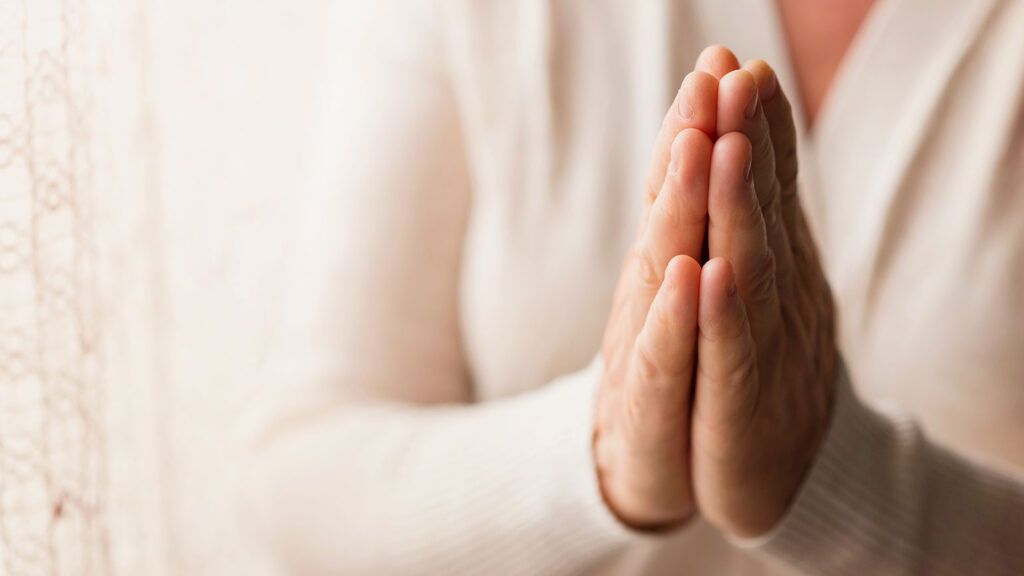 A woman's praying hands