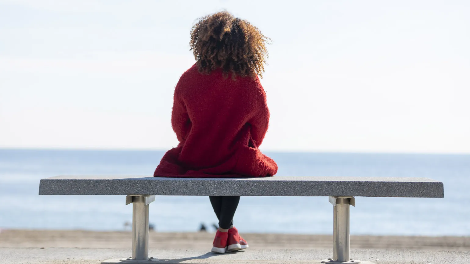 A woman sitting on a bench.