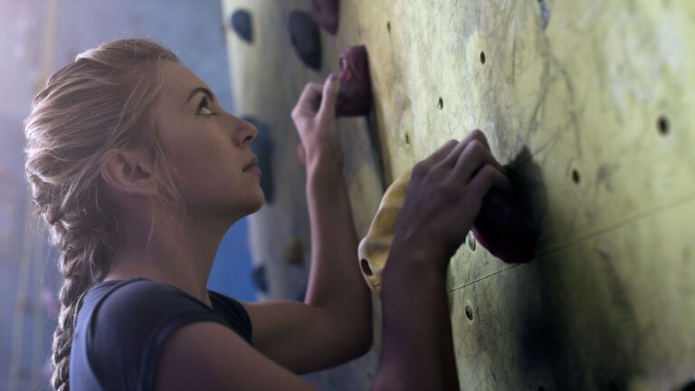 A woman on a rock-climbing wall