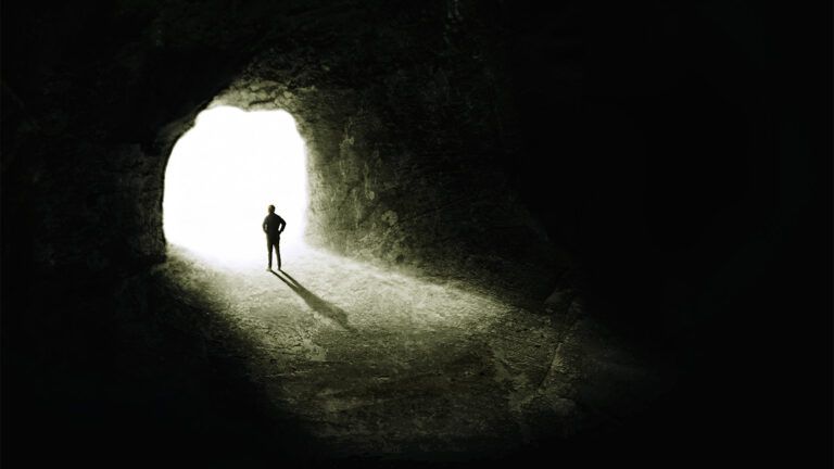 Man looking out from a cave