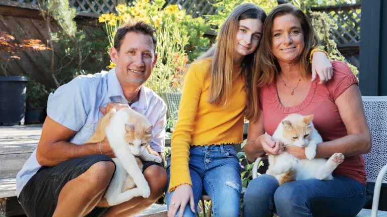 Brian, Cali and Cathleen at home with cats Butter and Ozzy.