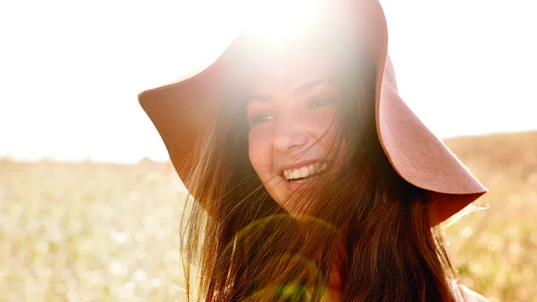 Young, smiling woman outdoors