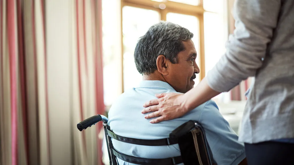 A caregivers looks after a veteran in a wheelchair