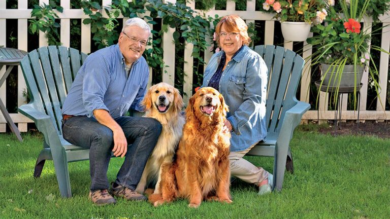 Peggy Frezon with her husband Mike, and her therapy dog Ernest. Photo by Roy Gumpel