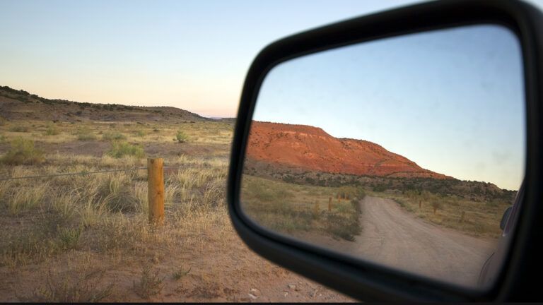A scenic view in a car's rearview mirror