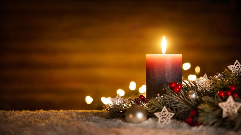 A lighted candle for the first Sunday of Advent