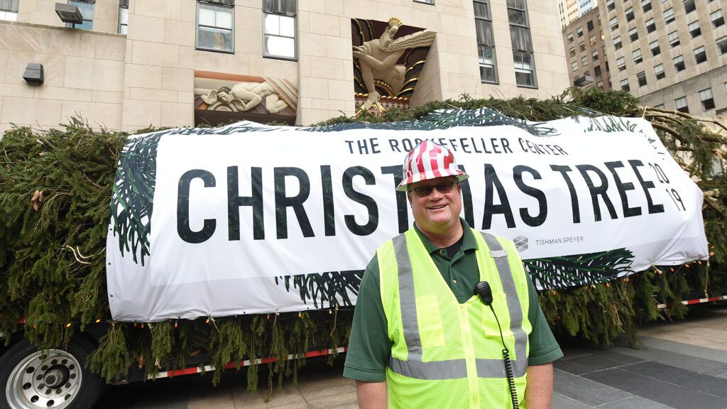 Erik Pauze with 2019 Rockefeller Center Christmas tree; Diane Bondareff/AP Images for Tishman Speyer