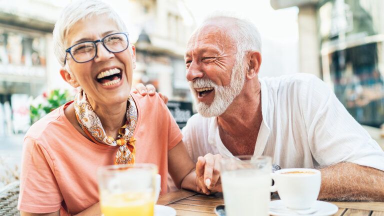 A mature couple enjoys a laugh