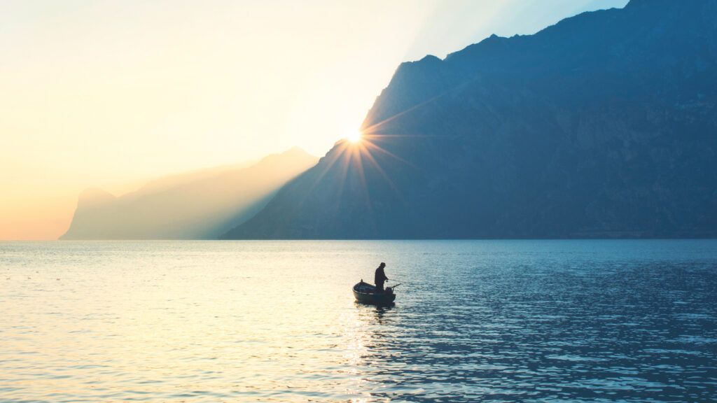 A fisherman in his boat on a lake; Getty Images