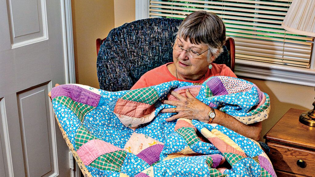 Brenda Graham with a quilt; photo courtesy Brenda Graham