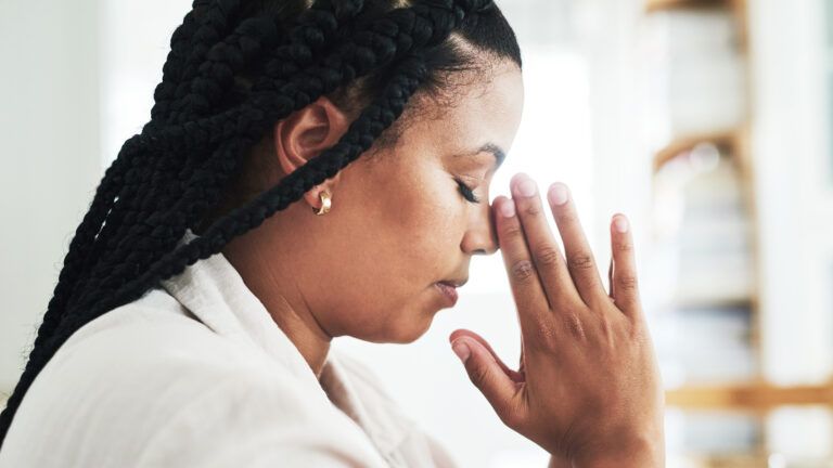 Woman praying at home to celebrate lent