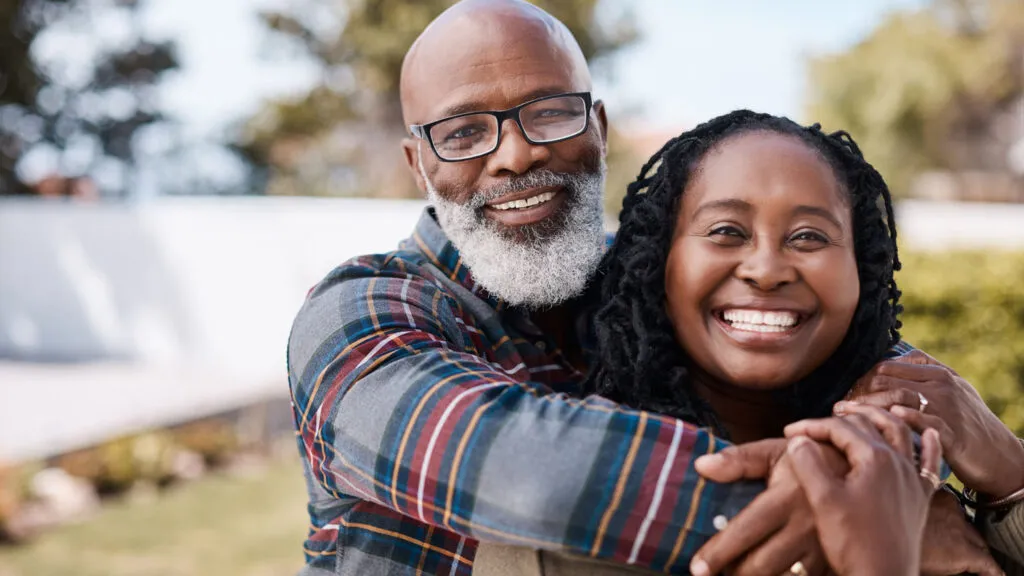 A happy couple embracing; Getty Images