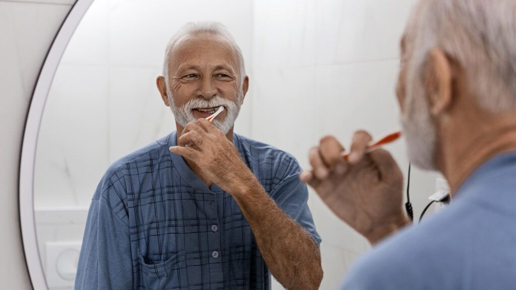 Senior brushing his teeth; Getty Images