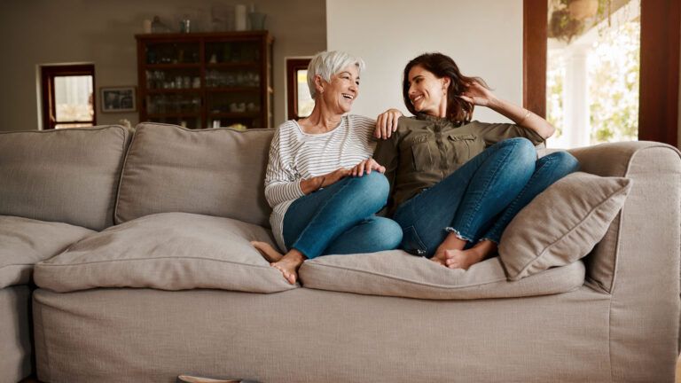 A mother and daughter talking on the couch; Getty Images
