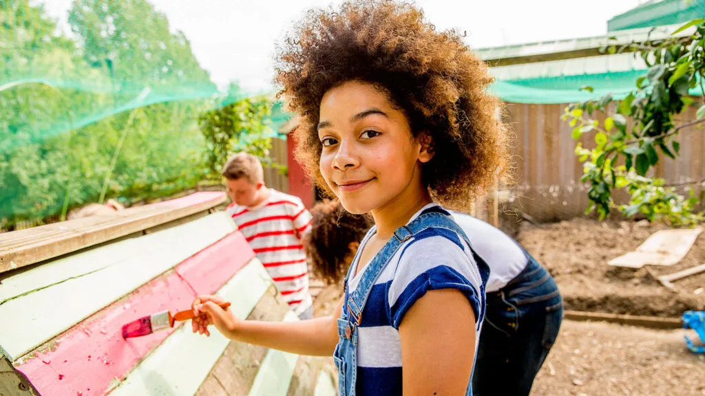 A young woman assists in renovating a house