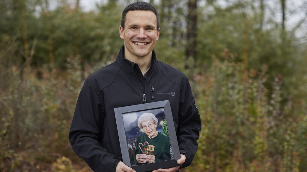 John Haney with a photo of his grandmother; photo by Natalia Weedy