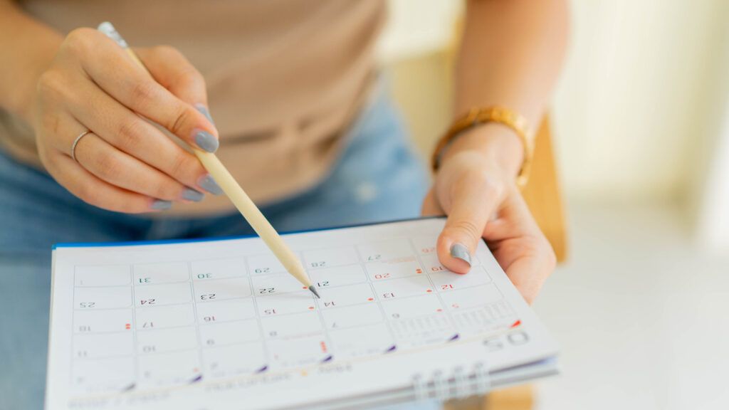Schedule time on a calendar; Getty Images