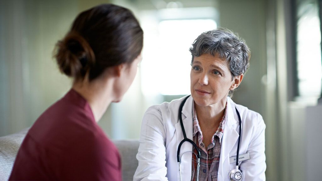 A woman meets with her doctor