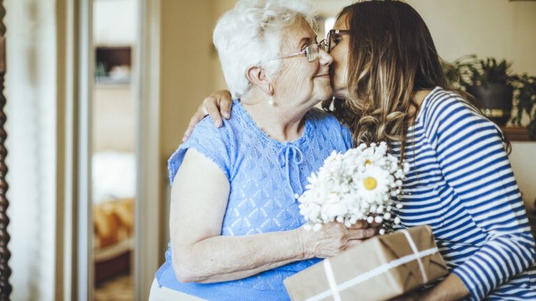 Senior woman is celebrating a joyful Mother's day moment with her daughter; Getty Images