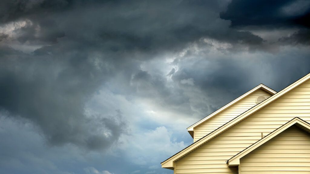 Gathering storm clouds over a house; photo credit: Getty Images