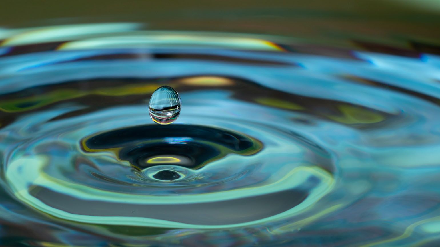 A single water droplet causing ripples in water; Getty Images
