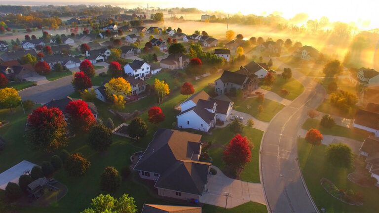 An aerial view of suburban homes at sunrise