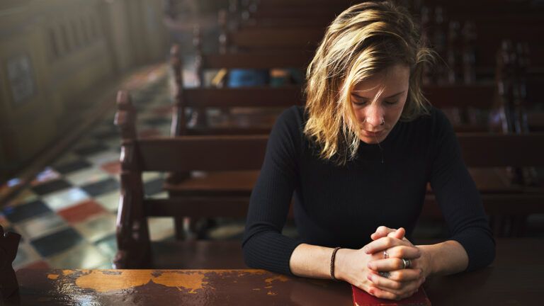 A womanh prays in church