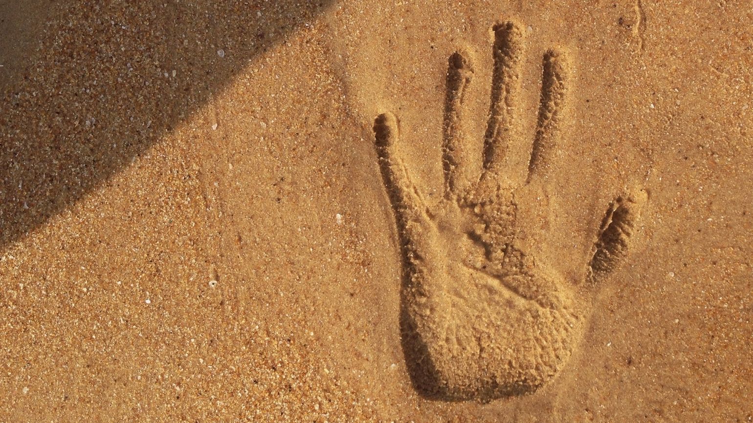 Handprint in the sand; Getty Images