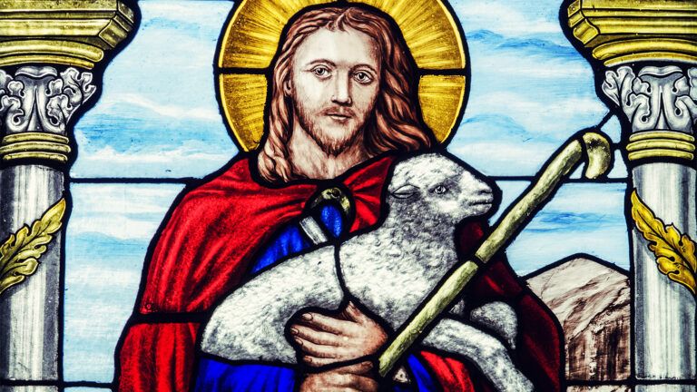 A stained glass window depicting Jesus as the Shepherd