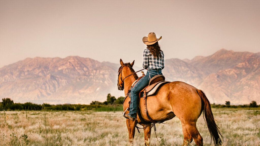 Woman Horseback Riding at Sunset (Getty Images)