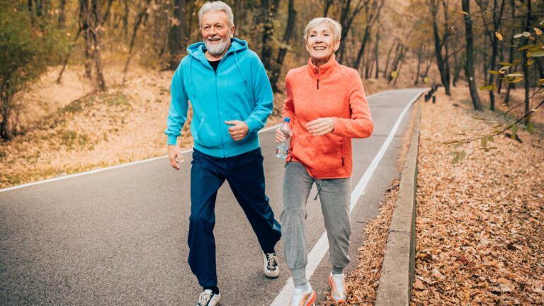 A senior couple running on a trail; Getty Images